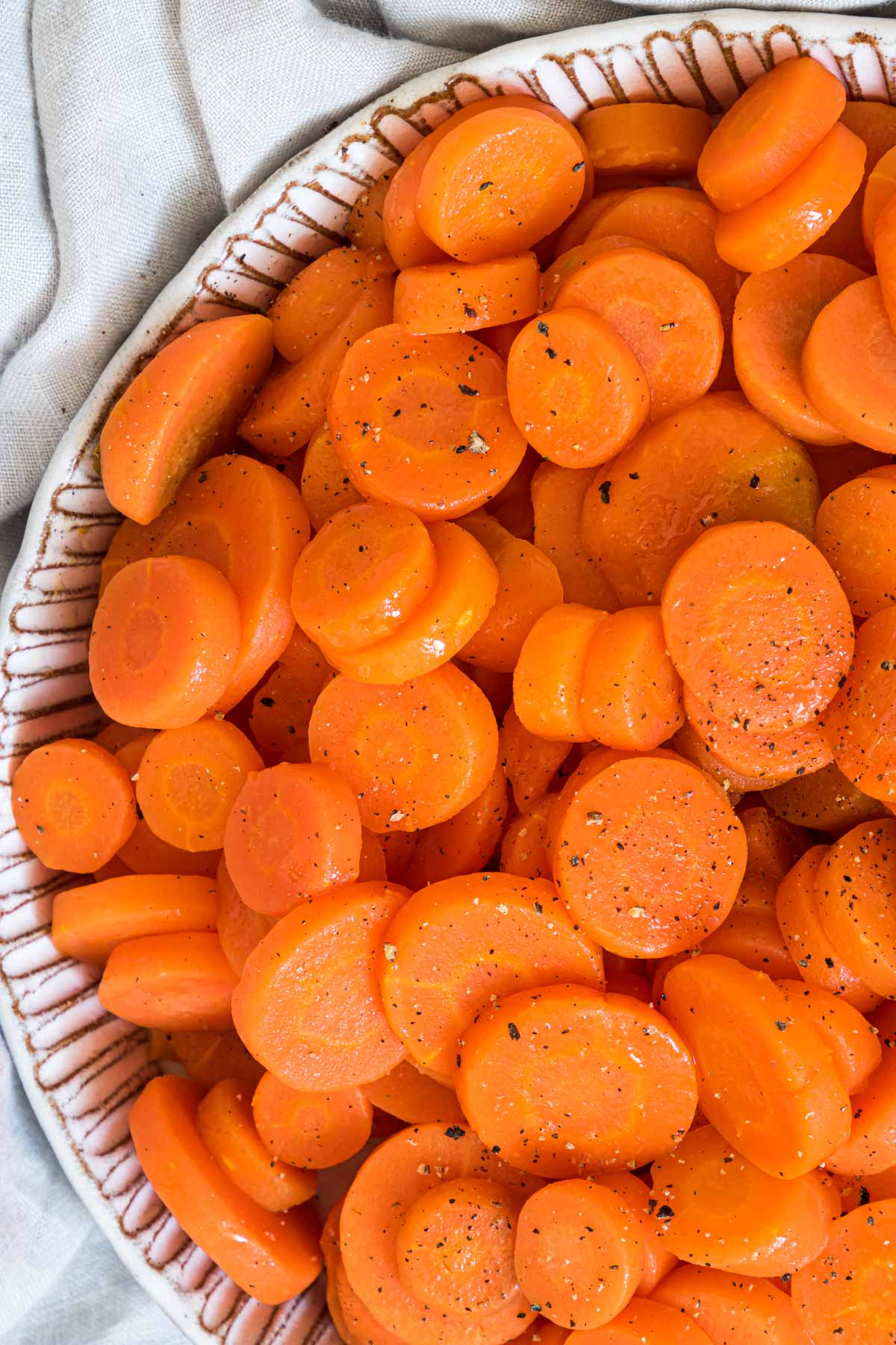 close up view of the finished microwave carrots in a serving bowl