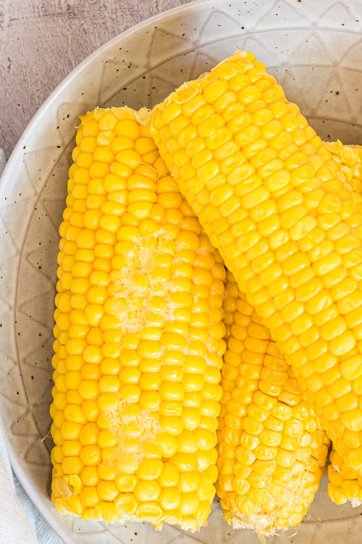 the finished microwave corn on the cob on a plate