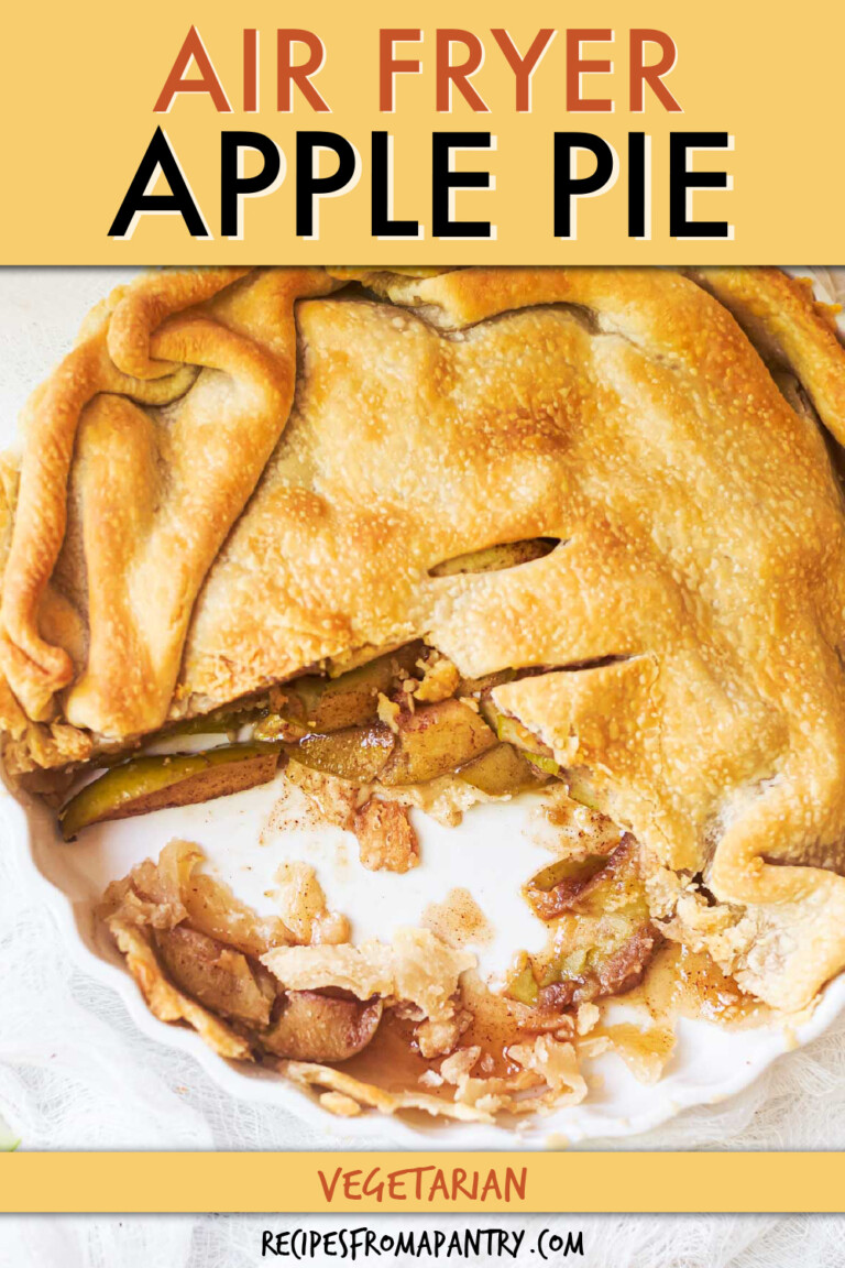 an apple pie in a pie dish with pieces cut out