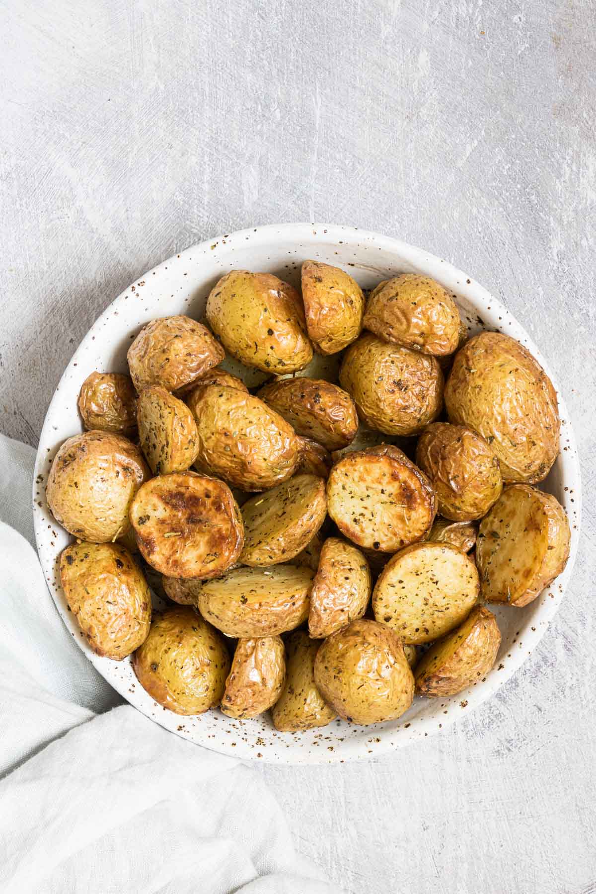 a bowl filled with the completed air fryer baby potatoes