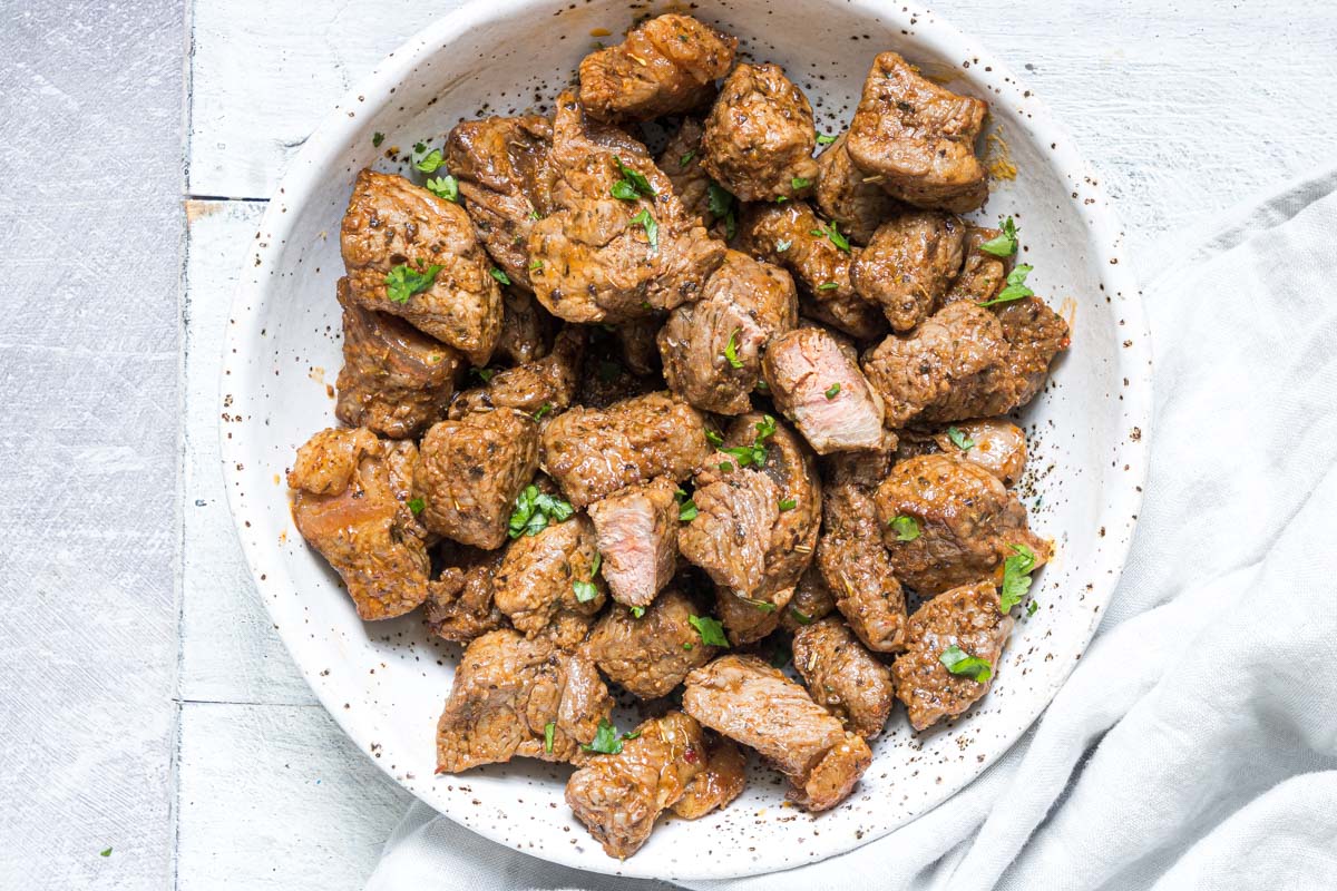 the air fryer steak bites in a bowl and ready to be served