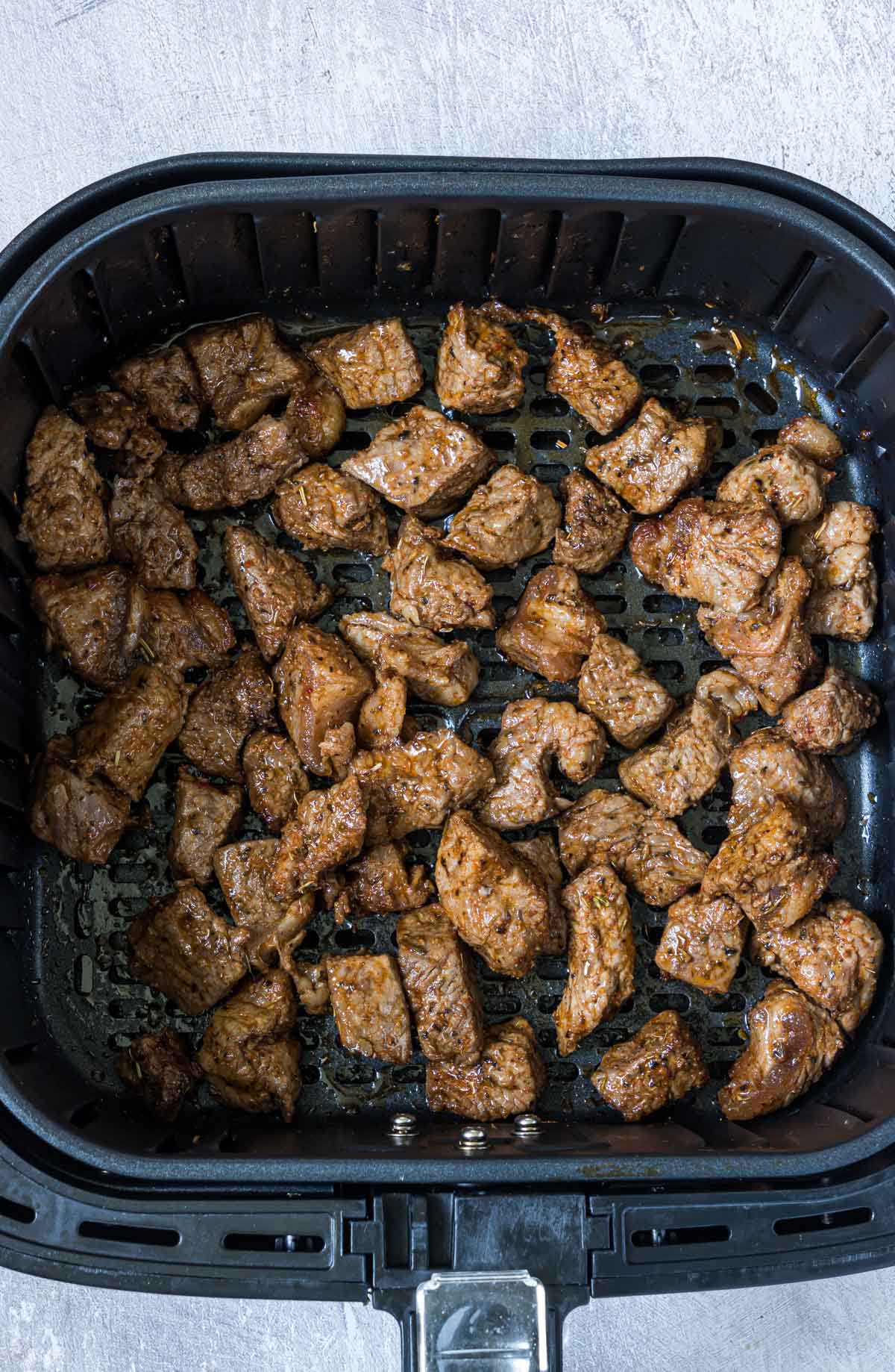 top down view of the completed steak bites in air fryer basket