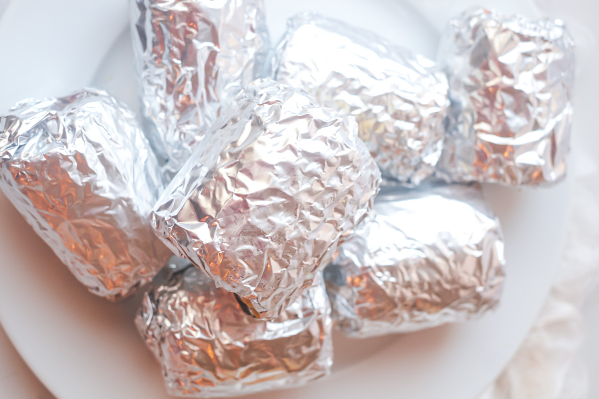 top down view of the corn on the cob in the oven wrapped in foil