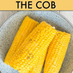 four corn cobs on a plate