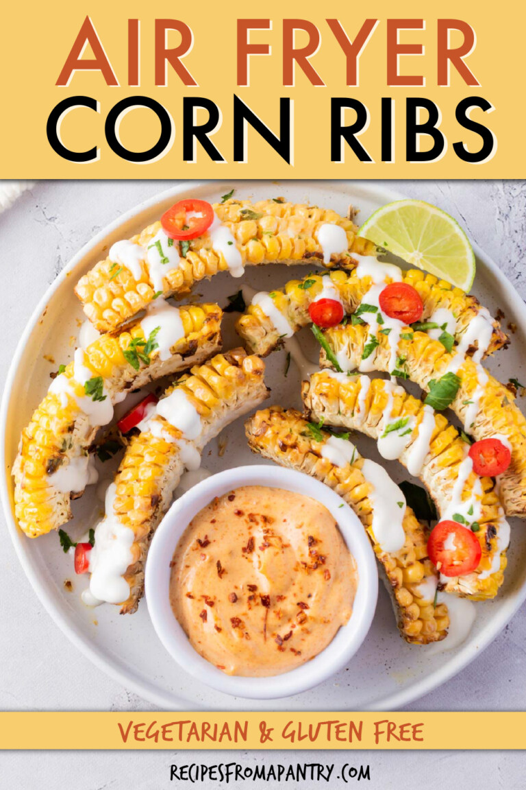 corn ribs on a round plate with small dish of dipping sauce