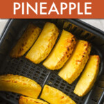 pineapple slices in an air fryer basket