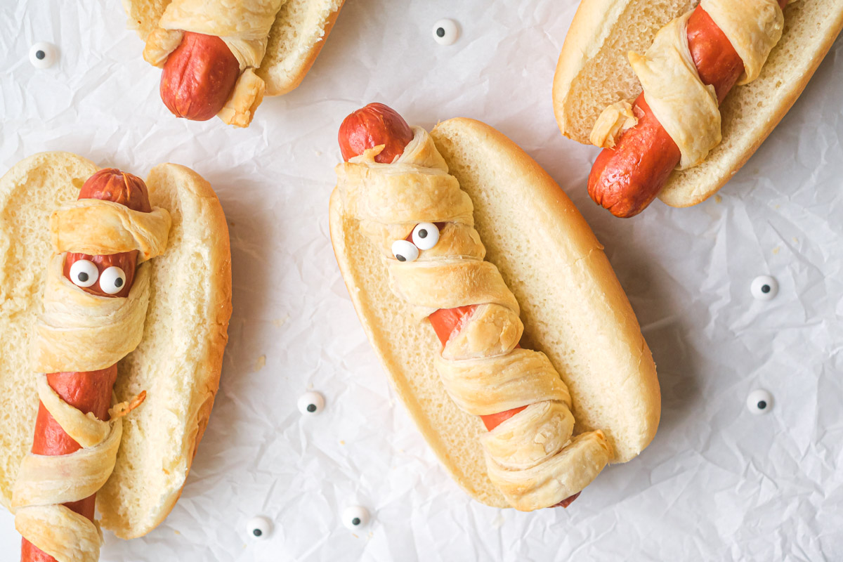 the completed air fryer mummy dogs recipe served with candy eye decorations
