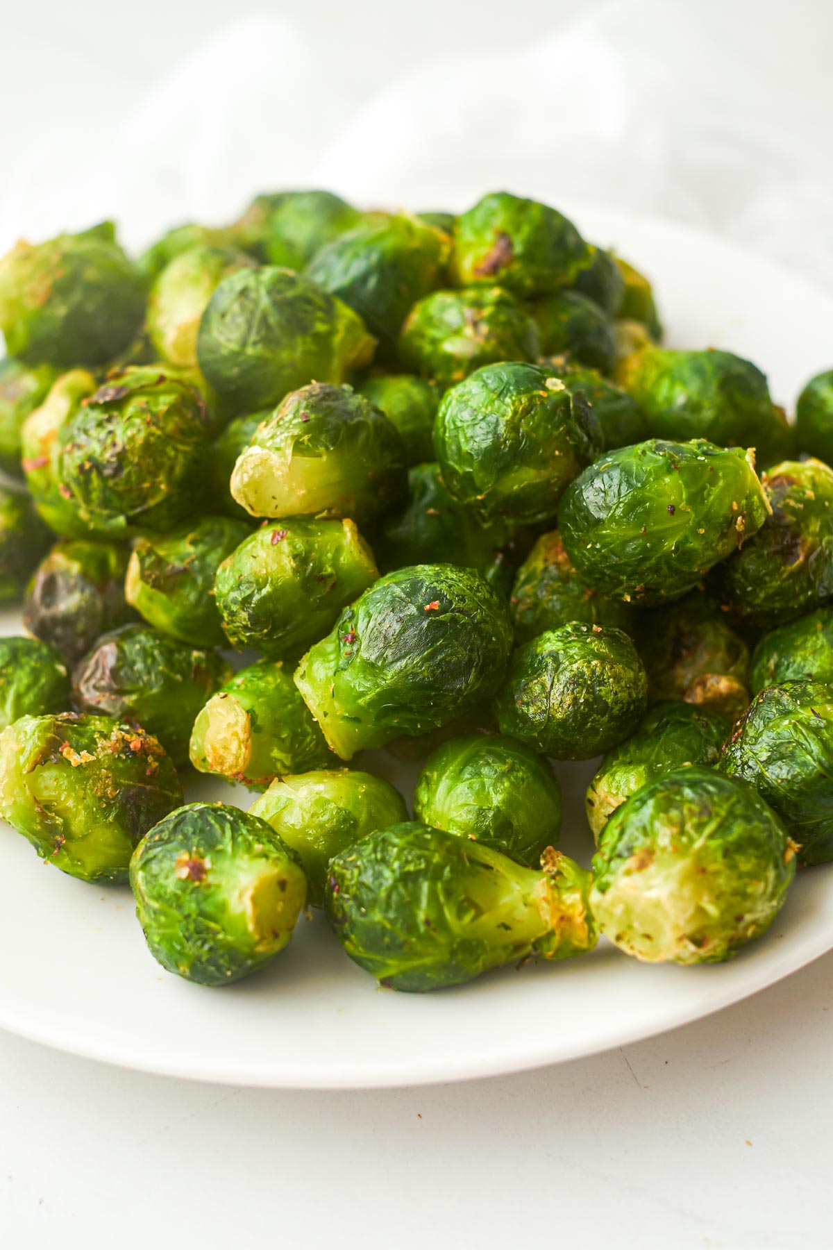 the cooked frozen brussel sprouts air fryer served on a white plate
