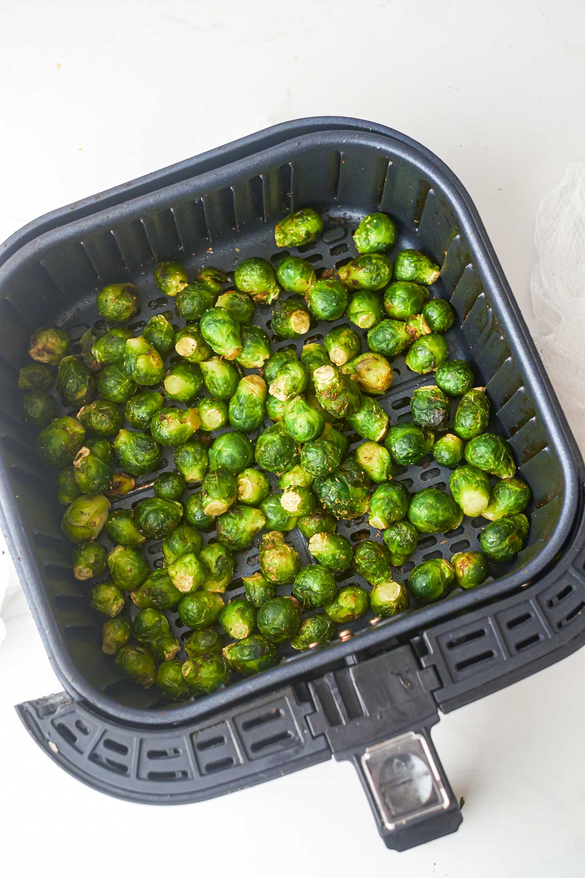 top down view of the cooked brussle sprouts inside the air fryer basket