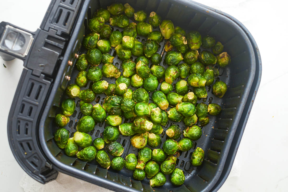top down view of the completed frozen brussels sprouts in the air fryer basket