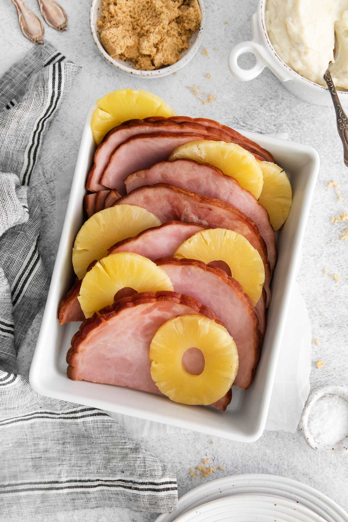 the finished instant pot ham and pineapples on a table with white dishes