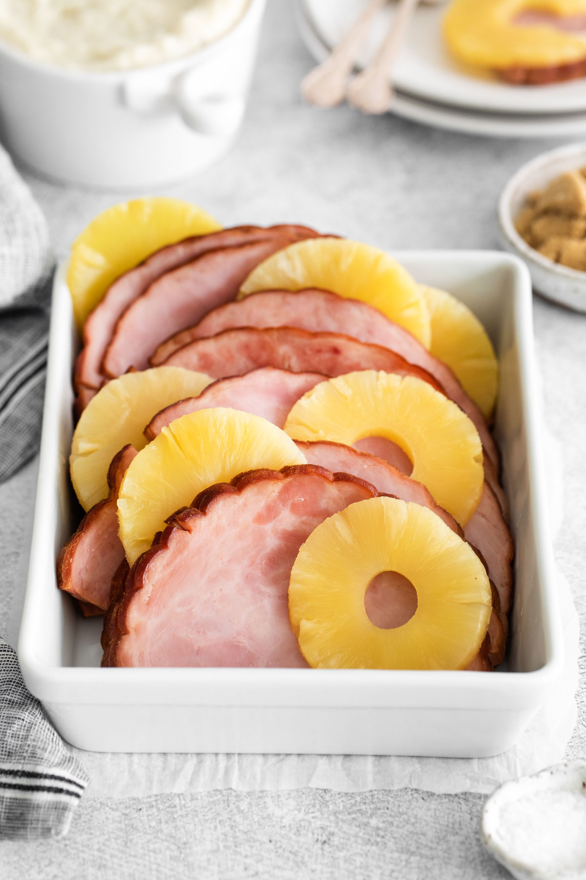 the completed instant pot ham in a white serving dish