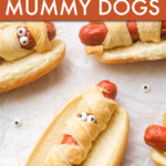 hot dogs wrapped in dough strips with candy eyes that look like mummies