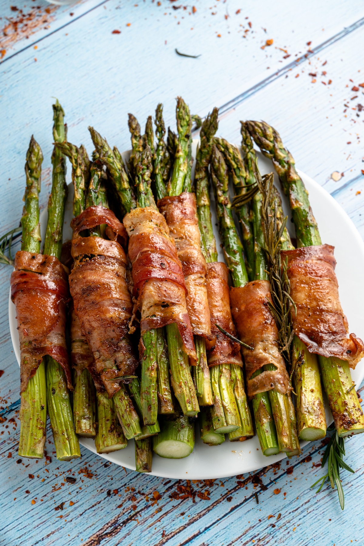 a stack of bacon wrapped asparagus on a plate