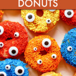 various donuts with different colored sprinkles and candy eyeballs