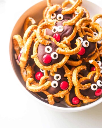 a bowl filled with pretzel reindeer treats