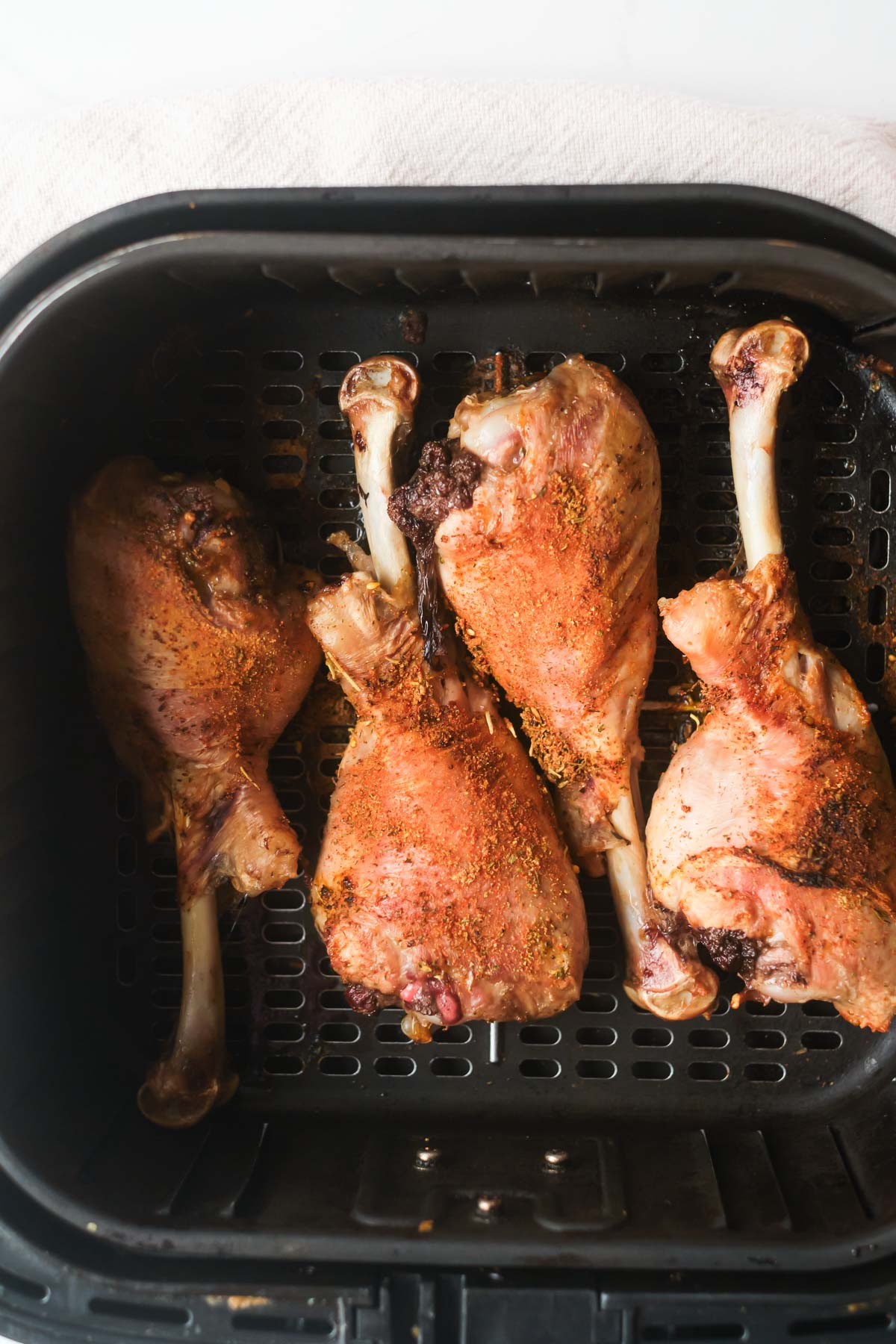 top down view of the cooked turkey legs in air fryer basket