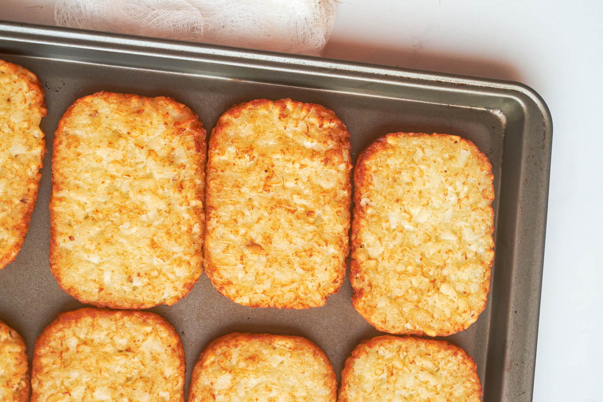 close up view of the frozen hash browns in oven