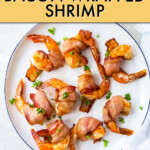 several cooked bacon wrapped shrimp on a plate