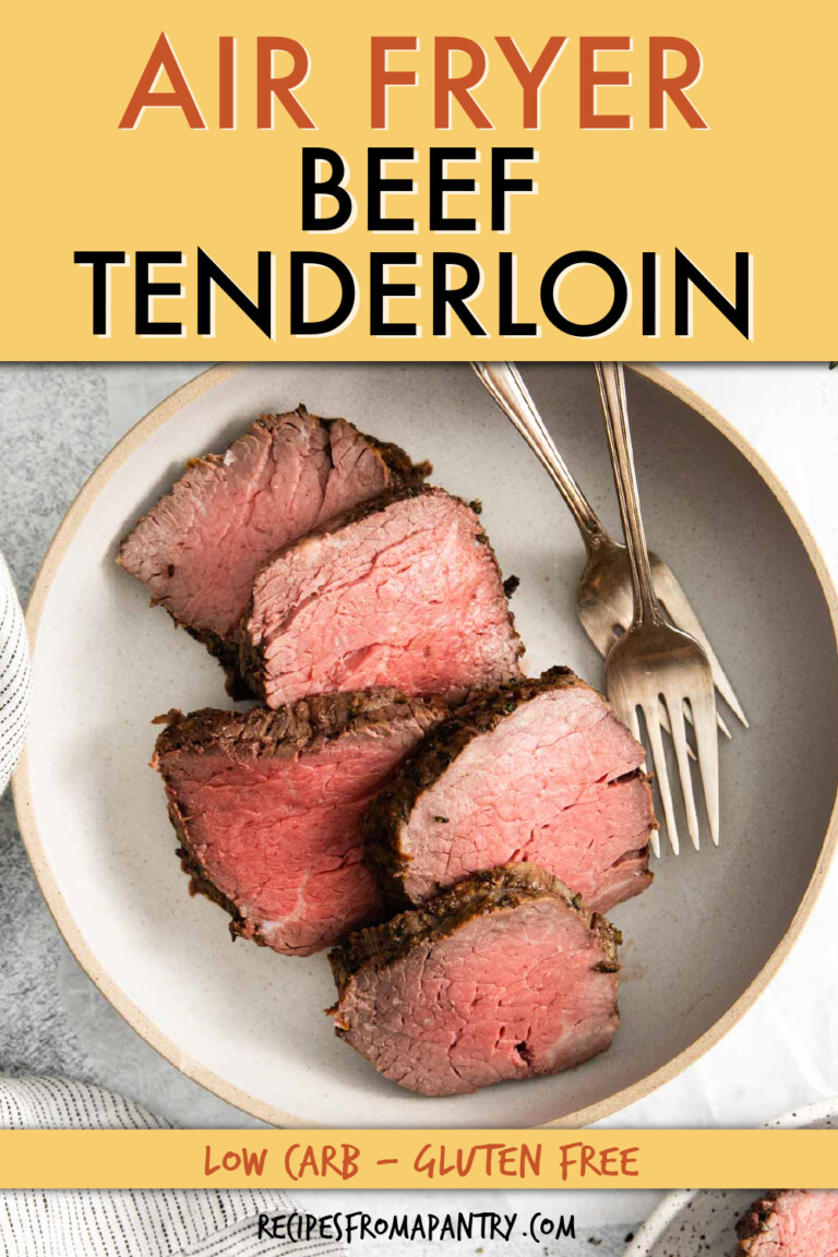 Beef tenderloin cut into slices on a serving plate with two forks