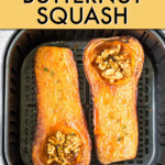 two halves of a butternut squashed stuffed with walnuts in an air fryer basket