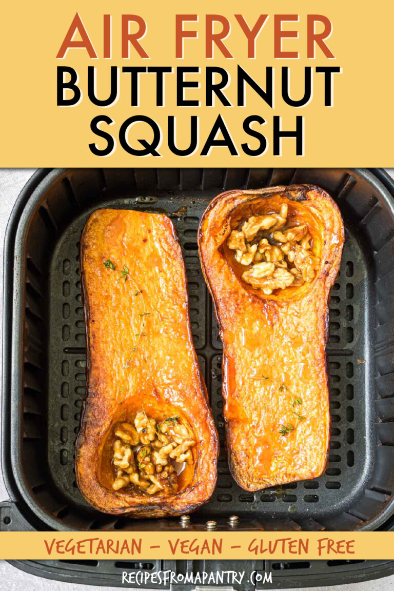two halves of a butternut squashed stuffed with walnuts in an air fryer basket