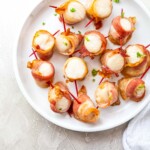 a plate filled with bacon wrapped scallops air fryer