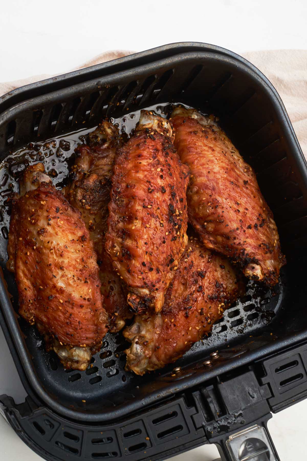 top down view of the turkey wings inside the air fryer basket