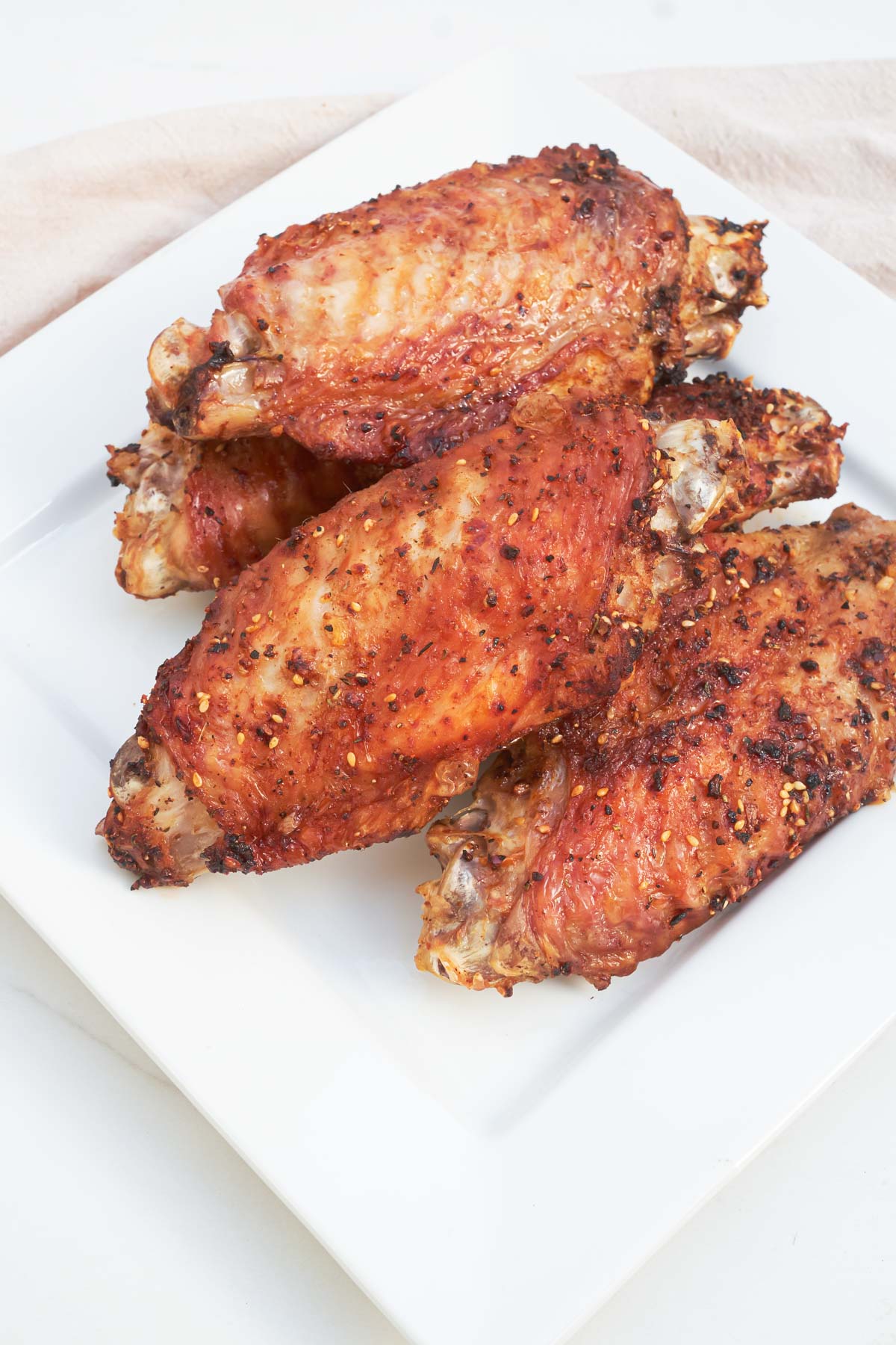 the completed air fryer turkey wings served on a white plate