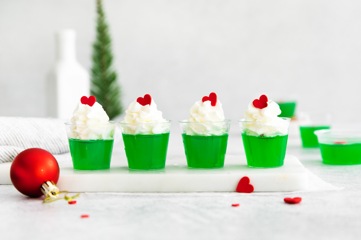 four grinch jello shots on a serving tray
