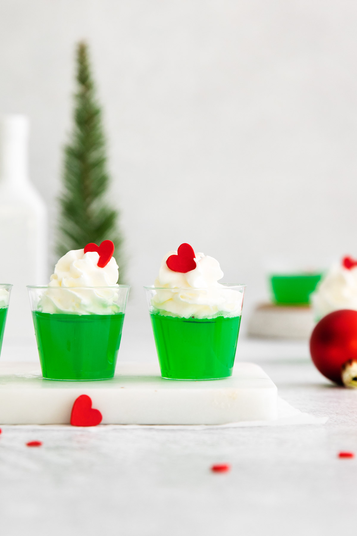 Two Grinch Jello shots on a table