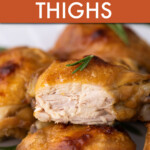 A close up of several cooked chicken thighs with one side open to show the meat.