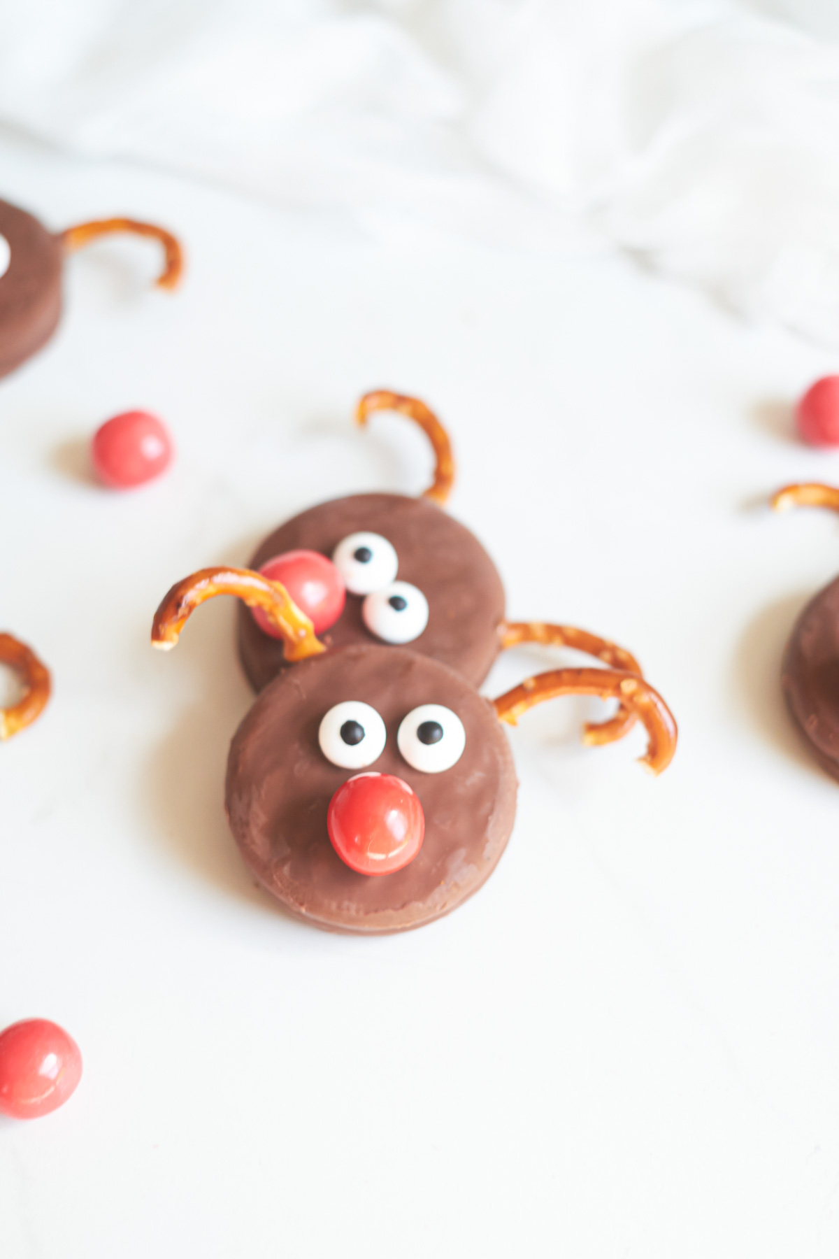 two of the finished oreo reindeer cookies stacked on one another
