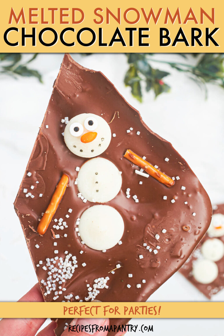 A piece of chocolate bark with a candy snowman in it.