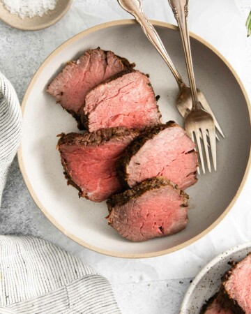 top down view of a plate filled with sliced beef tenderloin in air fryer
