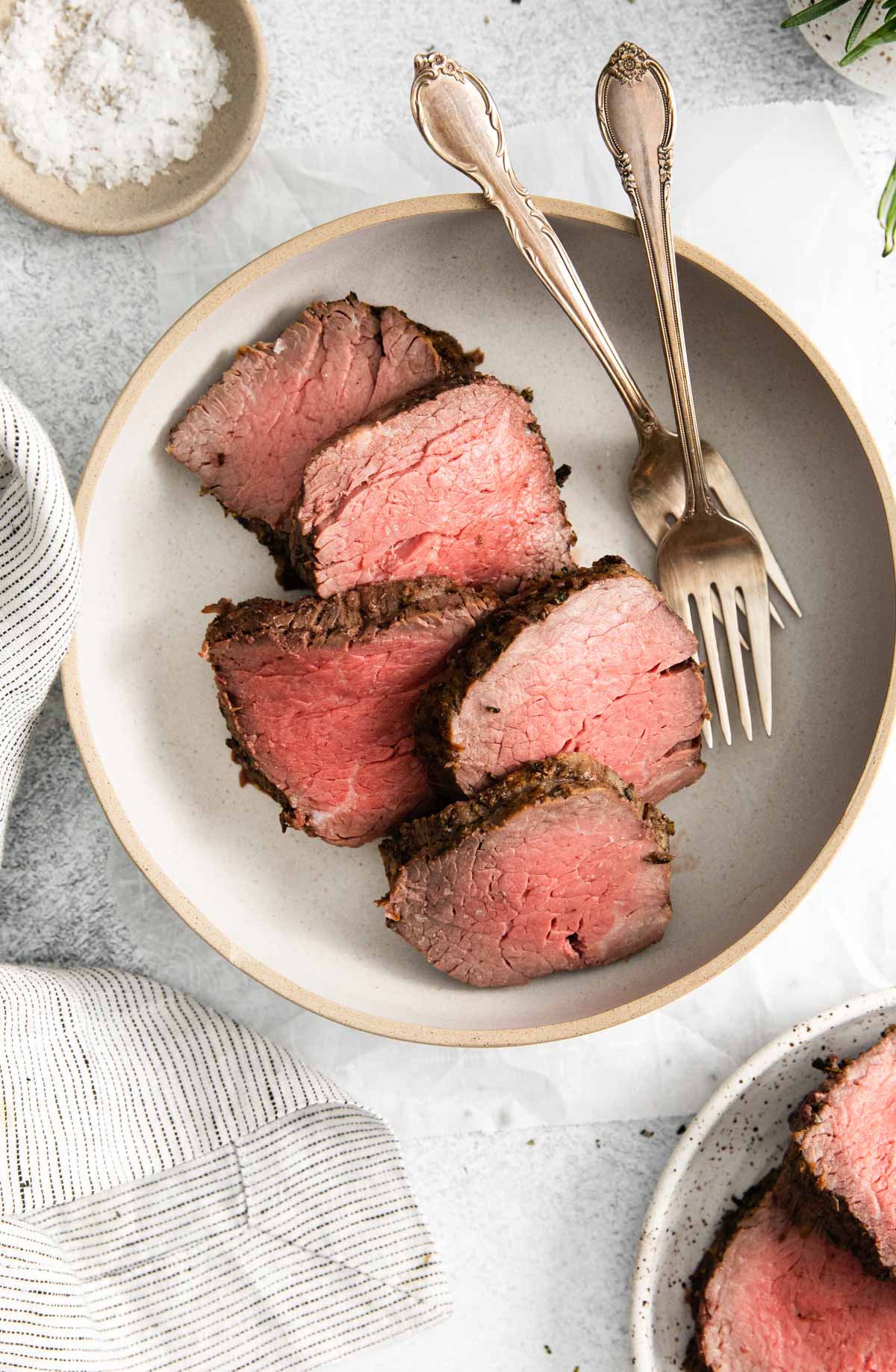 top down view of a plate filled with sliced beef tenderloin in air fryer