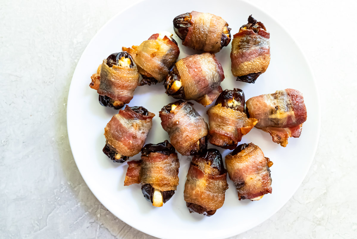 top down view of a plate filled with air fryer bacon wrapped dates