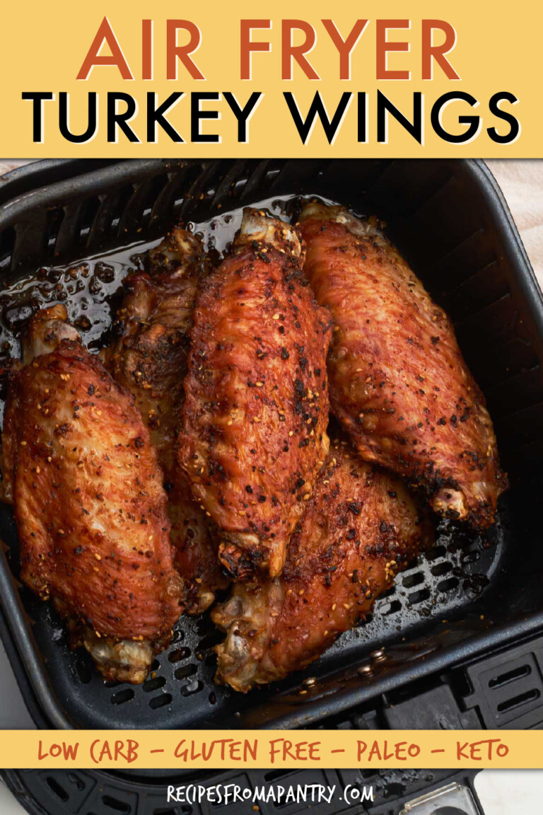 four cooked turkey wings in an air fryer basket