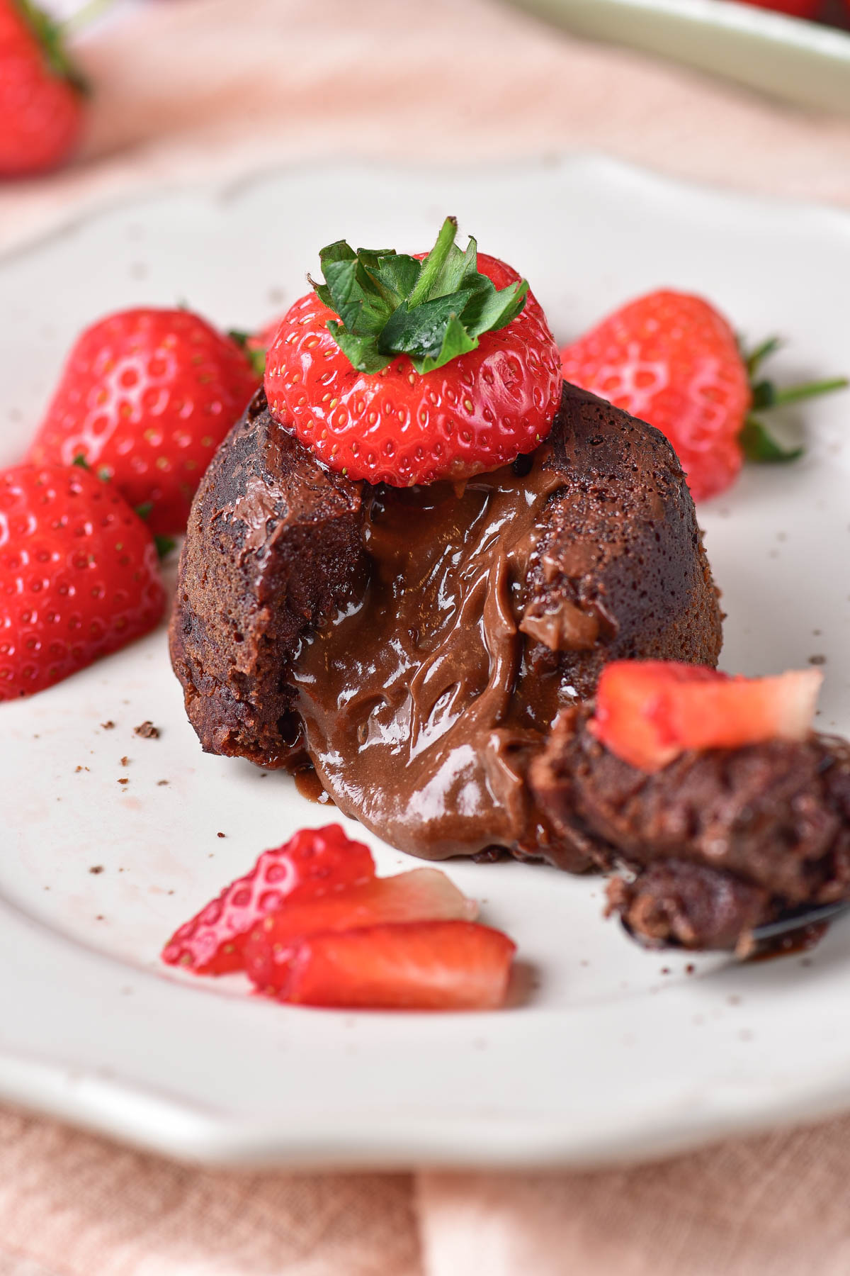 one chocolate lava cake served with strawberries