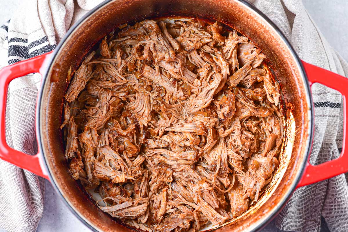 the completed pulled pork inside the dutch oven