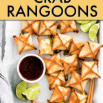 overhead view of crab rangoons on a dish with dipping sauce and chopsticks