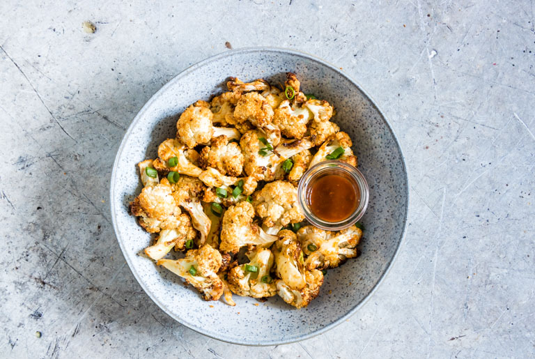 top down view of the completed cauliflower wings in a bowl