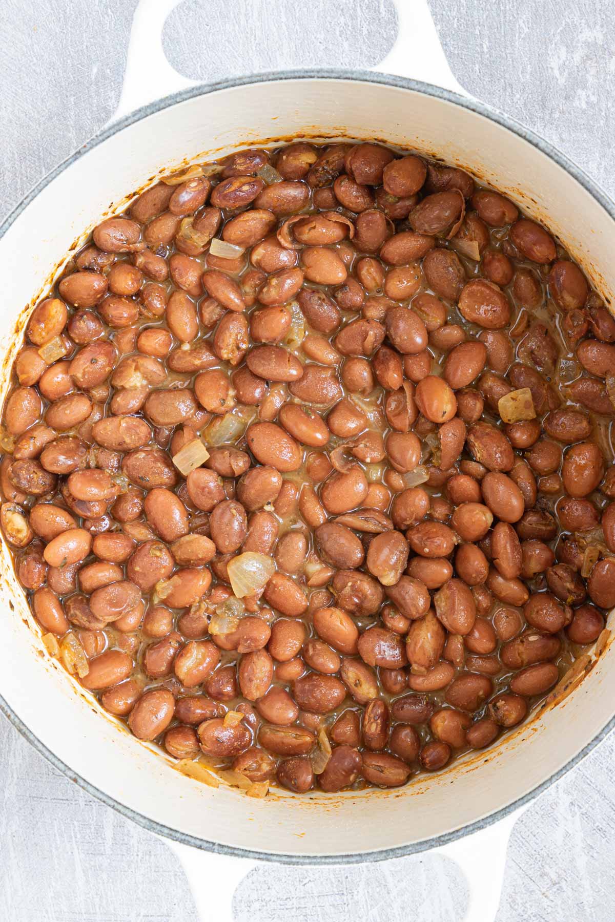 top down view of season pinto beans inside a stock pot