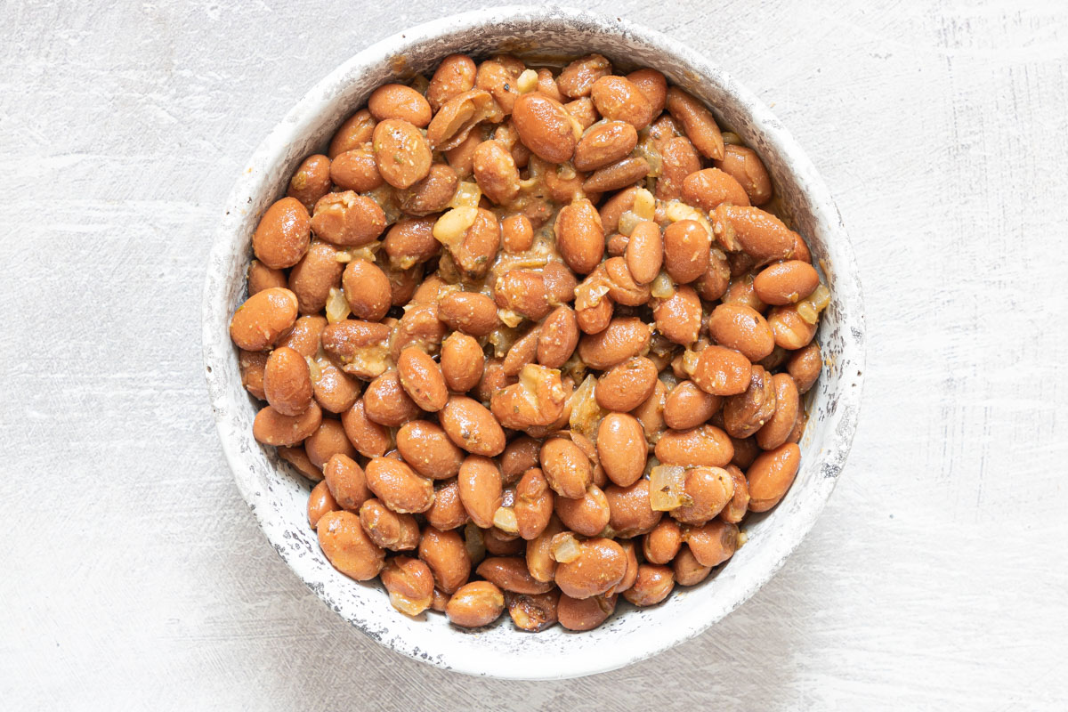 a bowl filled with the completed how to season pinto beans recipe