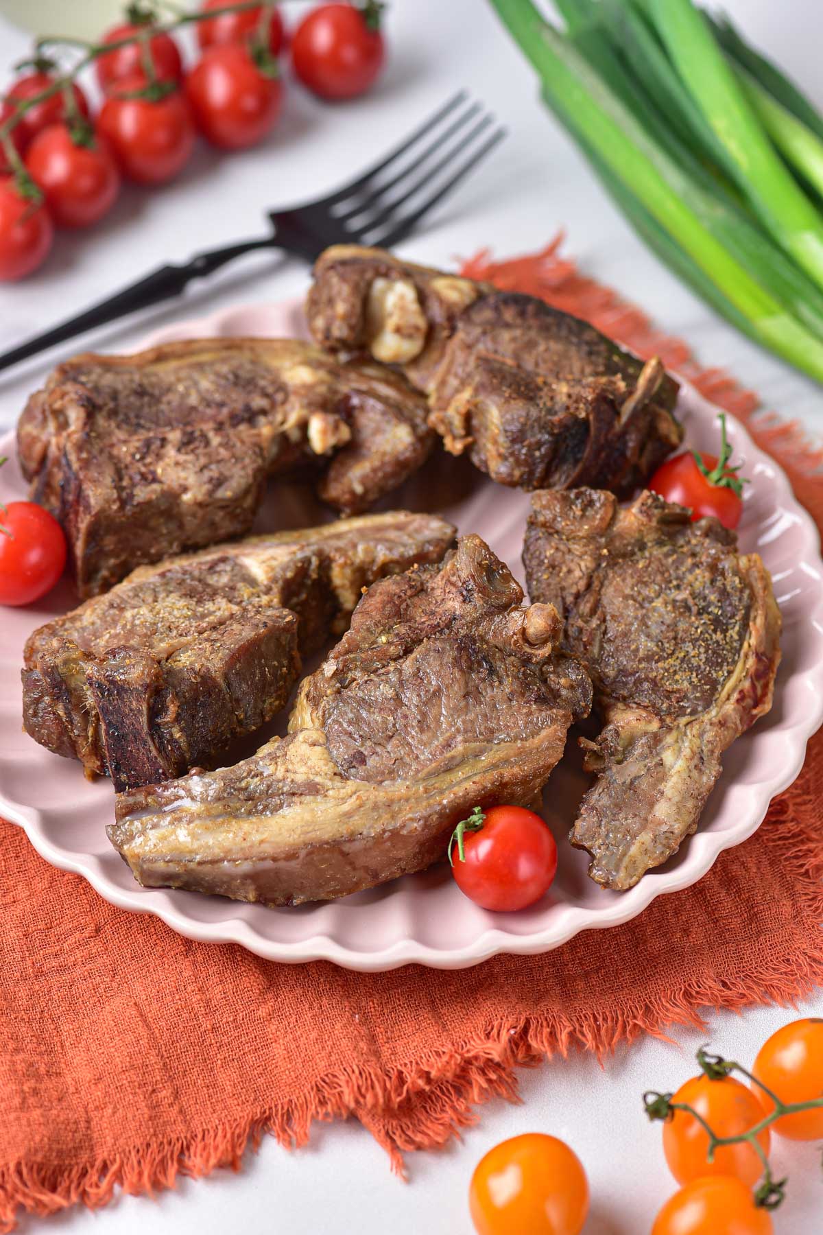 A plate of cooked lamb chops ready to serve