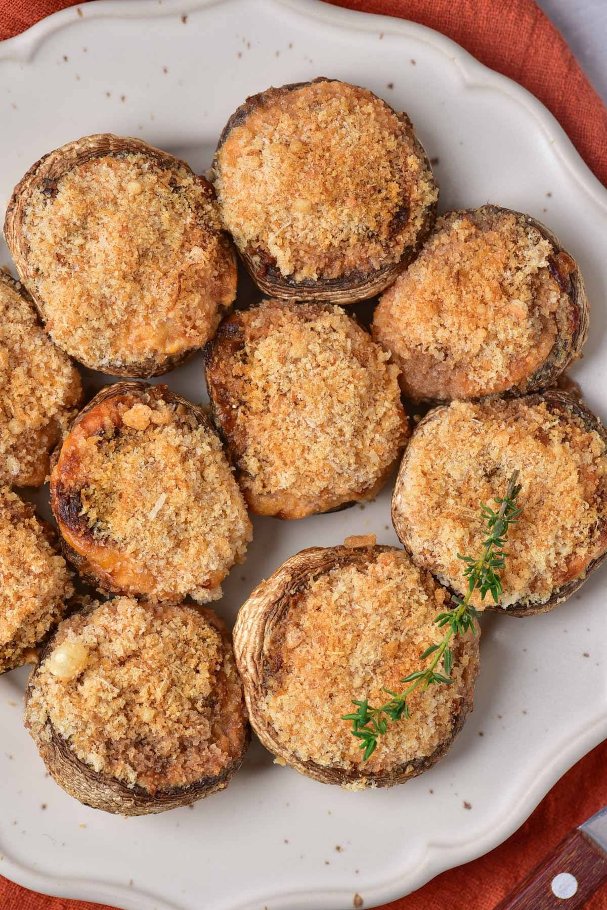 top down view of air fryer stuffed mushrooms on a white plate