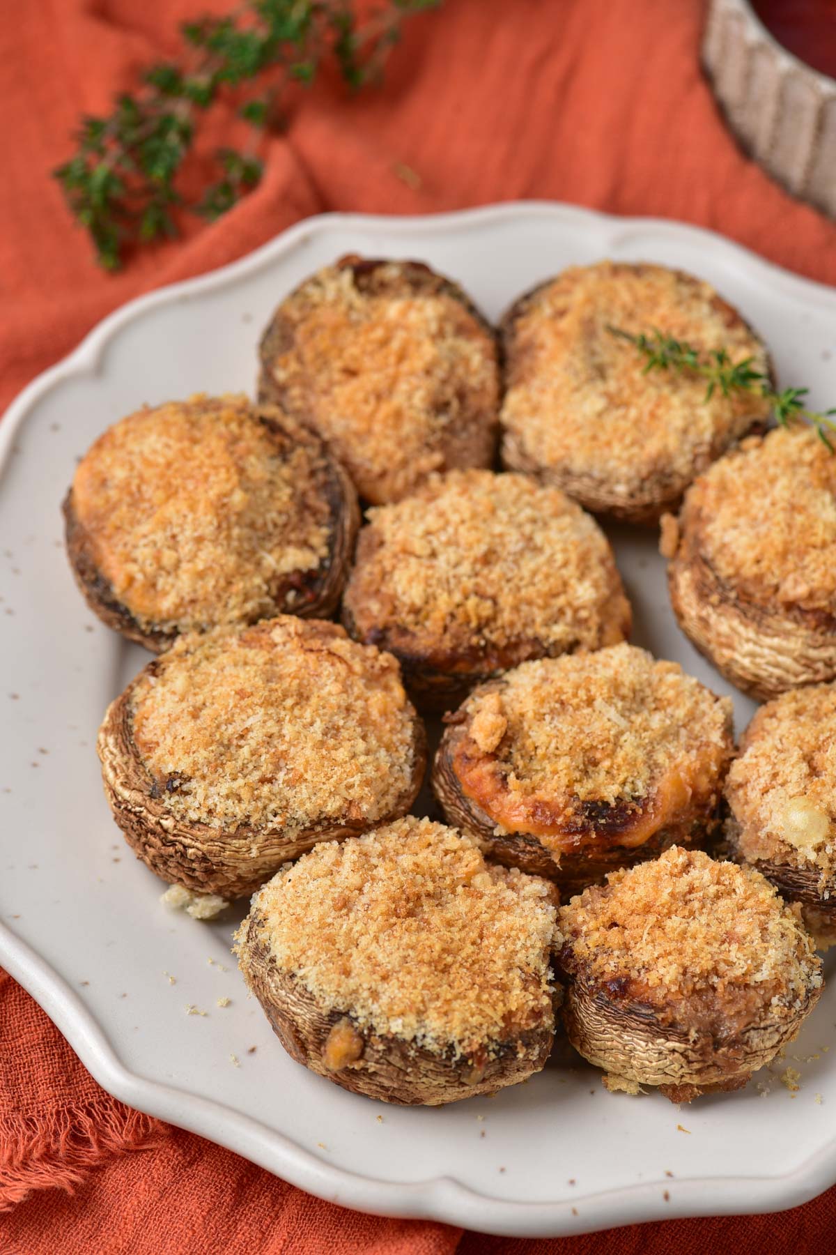 a plate filled with air fryer stuffed mushrooms set on an orange placemat