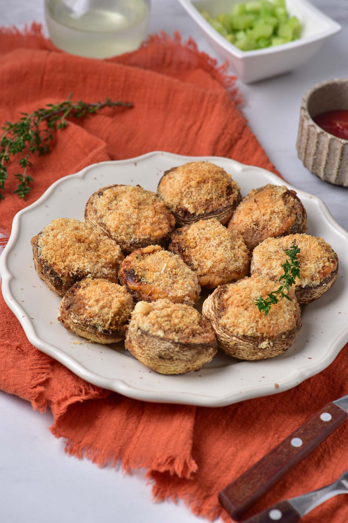 a plate of air fryer stuffed mushrooms served garnished with thyme