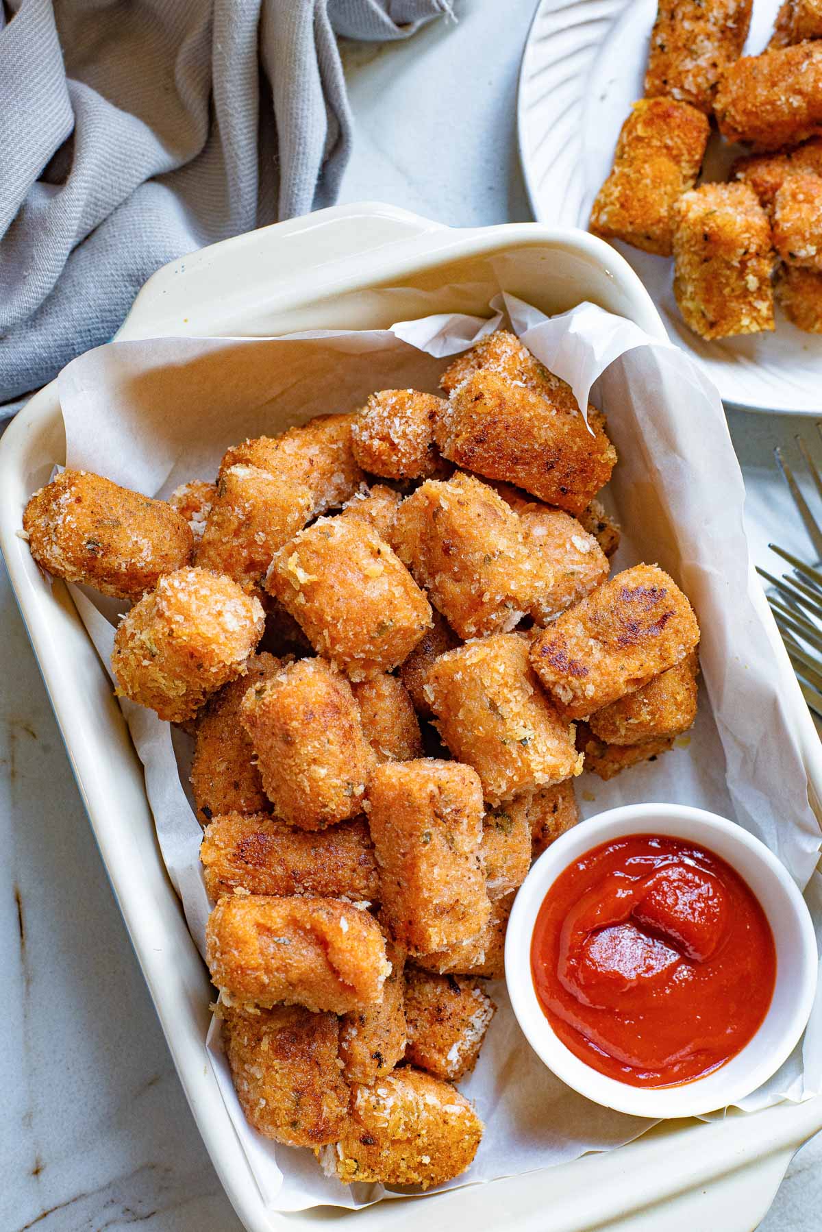 sweet potato tater tots in a baking dish with a side of ketchup