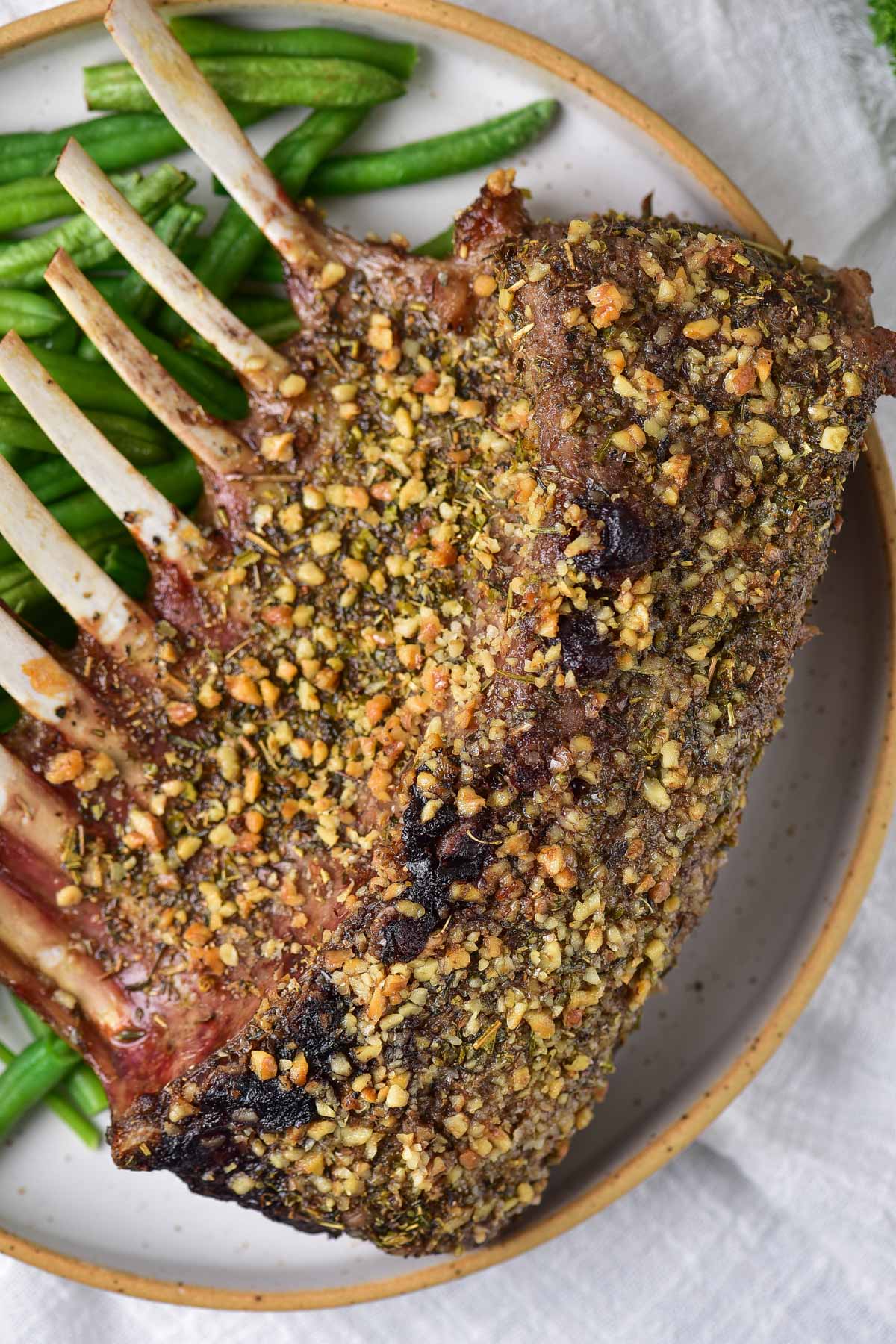 top down view of the completed air fryer rack of lamb on a serving platter